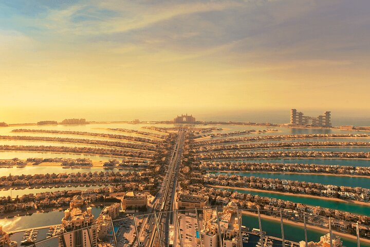 Experience the stunning skyline of Dubai featuring Atlantis The Palm Burj Al Arab and the scenic coastal area from both road and aerial perspectives making every moment unforgettable.